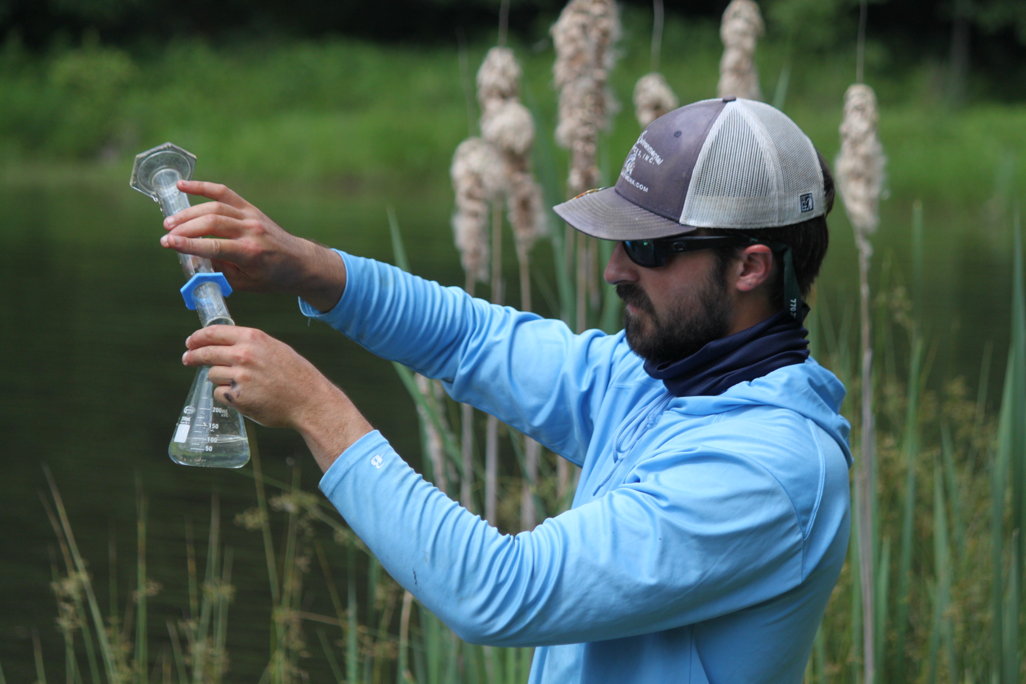 A technician pours water into a vial